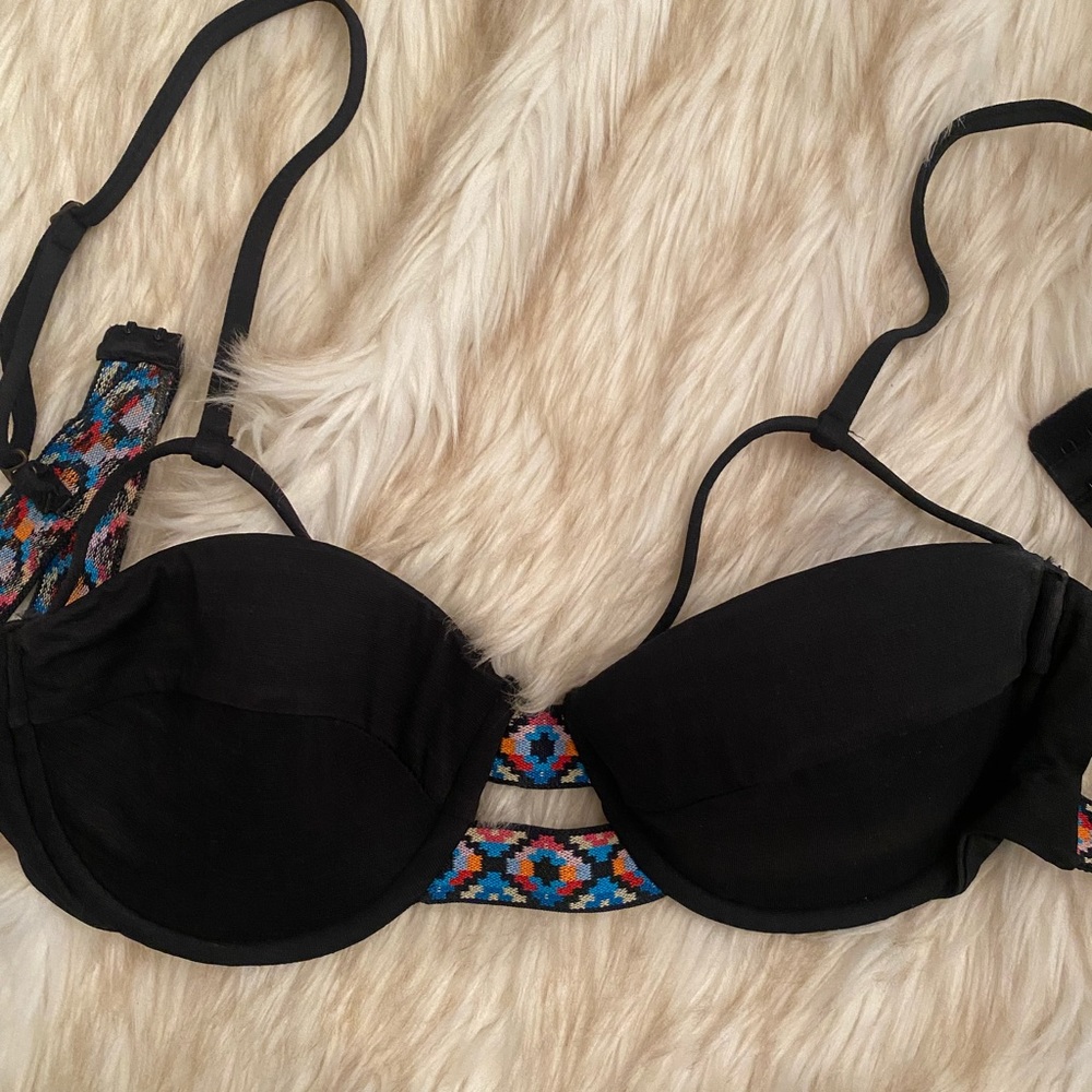 Black bikini top with unique straps above bust